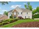 Charming two-story home with stone accents, manicured landscaping, and a lush green lawn at 641 Lake Overlook Dr, Canton, GA 30114