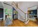 Elegant foyer featuring hardwood floors, staircase, and access to multiple living spaces at 641 Lake Overlook Dr, Canton, GA 30114