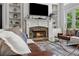 Living room with a stone fireplace, built-in shelving, large TV, and comfortable leather seating at 641 Lake Overlook Dr, Canton, GA 30114