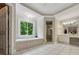 Bright main bathroom boasts a garden tub, a glass shower, and serene natural light at 641 Lake Overlook Dr, Canton, GA 30114