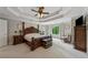Spacious main bedroom featuring a tray ceiling, four-poster bed, and abundant natural light at 641 Lake Overlook Dr, Canton, GA 30114