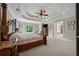 Main bedroom featuring tray ceiling, four-poster bed, and sitting area with backyard view at 641 Lake Overlook Dr, Canton, GA 30114