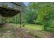 Large backyard with lush greenery and the home's deck, perfect for outdoor entertaining at 1201 Justin Ln, Lithonia, GA 30058