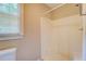 Bathroom featuring a walk-in shower, a window, and a toilet at 1201 Justin Ln, Lithonia, GA 30058