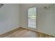 Bright room with neutral walls, wood-look flooring, and large window at 1201 Justin Ln, Lithonia, GA 30058