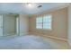 This bedroom offers a large window for natural light and ample closet space at 1201 Justin Ln, Lithonia, GA 30058