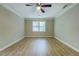 Bedroom with modern flooring, crown molding, a ceiling fan, and a large window for natural light at 1201 Justin Ln, Lithonia, GA 30058