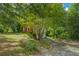 Charming two-story home with a well-manicured lawn and mature trees, creating a serene curb appeal at 1201 Justin Ln, Lithonia, GA 30058