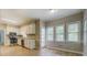 Eat-in kitchen with stainless appliances, white cabinets, and natural light from three large windows at 1201 Justin Ln, Lithonia, GA 30058