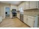 Cozy kitchen featuring stainless steel appliances, stone countertops, and bright lighting at 1201 Justin Ln, Lithonia, GA 30058