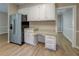 Charming kitchen with white cabinets, granite countertops, and stainless steel refrigerator at 1201 Justin Ln, Lithonia, GA 30058