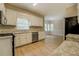 A modern kitchen with stainless steel appliances, light countertops, and new vinyl flooring at 1201 Justin Ln, Lithonia, GA 30058