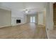 Spacious living room with new wood flooring, white brick fireplace, and French doors at 1201 Justin Ln, Lithonia, GA 30058