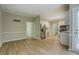 Open-concept room showcasing a kitchen and dining area with wood-look flooring at 1201 Justin Ln, Lithonia, GA 30058