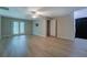 Bright living room with new floors, ceiling fan and glass doors leading to the back yard at 1201 Justin Ln, Lithonia, GA 30058