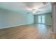 Spacious living room featuring new floors, ceiling fan, and access to the exterior via a set of glass doors at 1201 Justin Ln, Lithonia, GA 30058