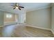 Large main bedroom with modern flooring, crown molding, a ceiling fan, and a soaking tub at 1201 Justin Ln, Lithonia, GA 30058