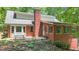 Brick home features a patio with mature landscaping at 150 Gill Ln, Stockbridge, GA 30281