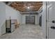 Basement room features exposed ceiling with duct work and storage, fridge and chairs at 150 Gill Ln, Stockbridge, GA 30281