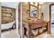 This rustic bathroom has a stand alone tub, wood accents, brick accents, and a wooden vanity at 150 Gill Ln, Stockbridge, GA 30281