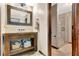This bathroom features a rustic wooden vanity, decorative mirror, and a large walk-in shower at 150 Gill Ln, Stockbridge, GA 30281