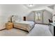This bedroom features neutral colors, carpeted floors, and natural lighting through large windows at 150 Gill Ln, Stockbridge, GA 30281