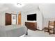 Bedroom includes a TV, wood furniture, neutral walls and carpeted flooring at 150 Gill Ln, Stockbridge, GA 30281
