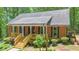 Exterior features brick facade, front porch and mature landscaping at 150 Gill Ln, Stockbridge, GA 30281