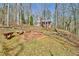 Outdoor brick firepit with benches nestled in a wooded landscape at 150 Gill Ln, Stockbridge, GA 30281