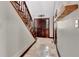 Inviting foyer features wooden banister staircase, tile flooring, and decorative lighting at 150 Gill Ln, Stockbridge, GA 30281