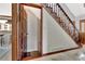 The foyer connects to a staircase and bar area, all within a home featuring classic woodworking at 150 Gill Ln, Stockbridge, GA 30281