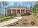 Attractive brick home with a covered front porch, walkway, and garden at 150 Gill Ln, Stockbridge, GA 30281