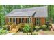 Charming brick home with a welcoming front porch and well-maintained landscaping at 150 Gill Ln, Stockbridge, GA 30281