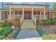 A close-up of a brick house showcasing a porch with a walkway and a well-manicured lawn at 150 Gill Ln, Stockbridge, GA 30281