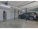 Spacious garage area featuring concrete floors, a SUV and interior and exterior doors at 150 Gill Ln, Stockbridge, GA 30281