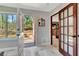 Hallway featuring tile floors, French doors, and an entryway to the exterior at 150 Gill Ln, Stockbridge, GA 30281