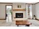 Bright living room with a fireplace, large windows, and tile flooring at 150 Gill Ln, Stockbridge, GA 30281