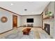 Open living room with a fireplace, exposed beams, natural light, and views of the property at 150 Gill Ln, Stockbridge, GA 30281