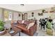 Inviting living room with a leather couch, baby grand piano, and tile floors at 150 Gill Ln, Stockbridge, GA 30281