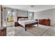 This main bedroom features a wood frame bed, natural lighting, and a neutral toned color palette at 150 Gill Ln, Stockbridge, GA 30281