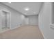 Spacious unfinished basement area with neutral walls, carpeted floors, and multiple entry doors at 1735 Peachtree Ne St # 624, Atlanta, GA 30309