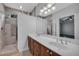 Bathroom features a double sink vanity, tiled shower and tub, and natural light at 1735 Peachtree Ne St # 624, Atlanta, GA 30309