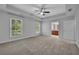 Bright bedroom showcasing neutral walls, tray ceiling, and ensuite bathroom access at 1735 Peachtree Ne St # 624, Atlanta, GA 30309