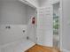 Laundry room featuring white tiled floors and access to another room at 1735 Peachtree Ne St # 624, Atlanta, GA 30309
