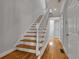 Bright staircase with hardwood steps and white railings. Door to the side at 1735 Peachtree Ne St # 624, Atlanta, GA 30309