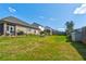 Spacious backyard with a screened porch, patio furniture, and a well-maintained lawn at 64 Citadel Dr, Hampton, GA 30228
