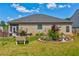 Lush backyard featuring manicured lawn, mature landscaping, and comfortable seating, perfect for outdoor activities at 64 Citadel Dr, Hampton, GA 30228