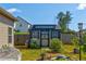 Backyard shed with an elegant design, surrounded by a well-manicured lawn and a wooden fence at 64 Citadel Dr, Hampton, GA 30228