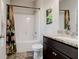 Well-maintained bathroom offers a shower-tub combo, attractive tile flooring, and a modern vanity at 64 Citadel Dr, Hampton, GA 30228