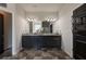 Bathroom with a double vanity, large mirror, modern fixtures, and neutral tile floors at 64 Citadel Dr, Hampton, GA 30228